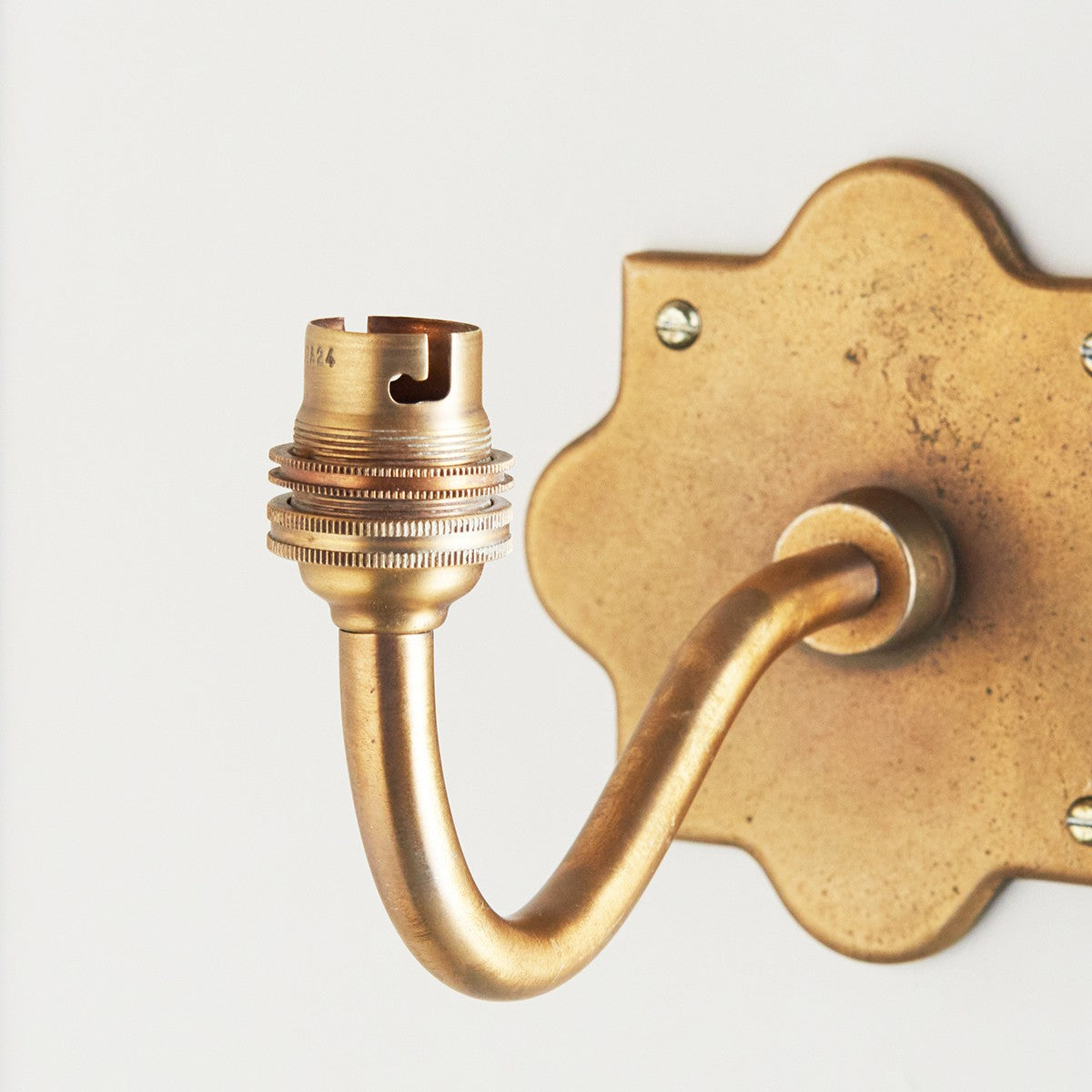 Rivet Curva Antique Brass Wall Light with Artisan Sand Casting