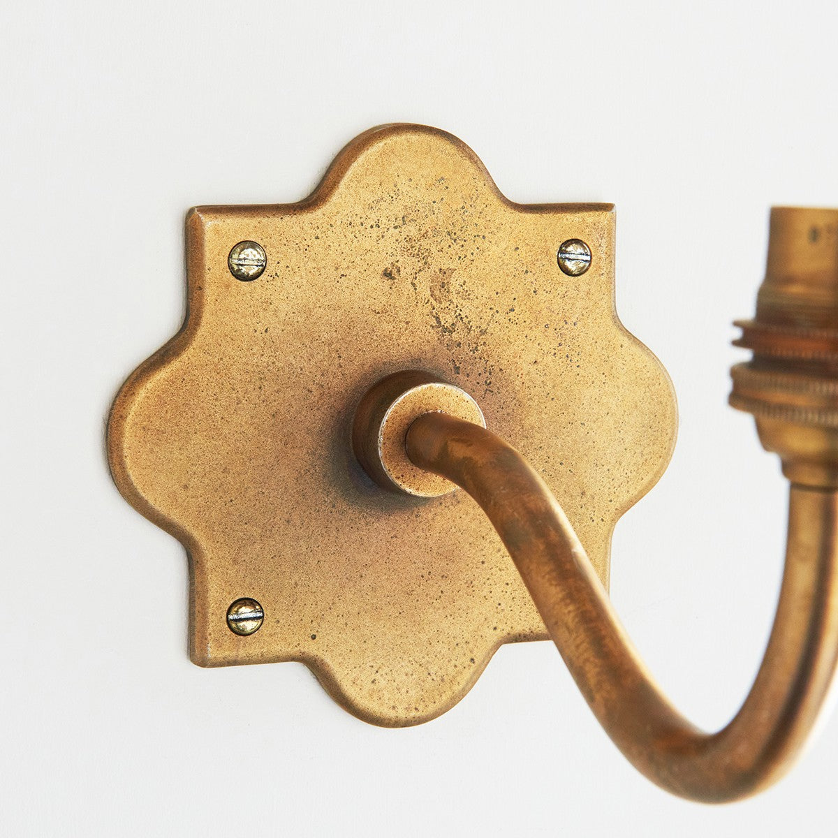 Rivet Curva Antique Brass Wall Light with Artisan Sand Casting