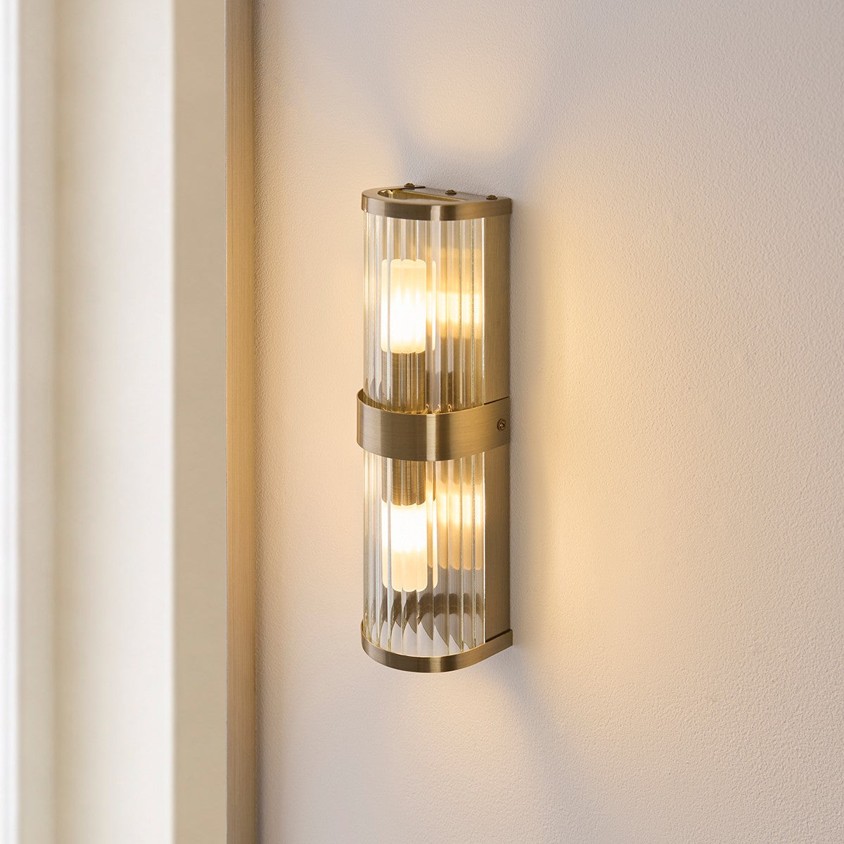 Radley Twin Bathroom Wall Light in Antique Brass with Ribbed Glass