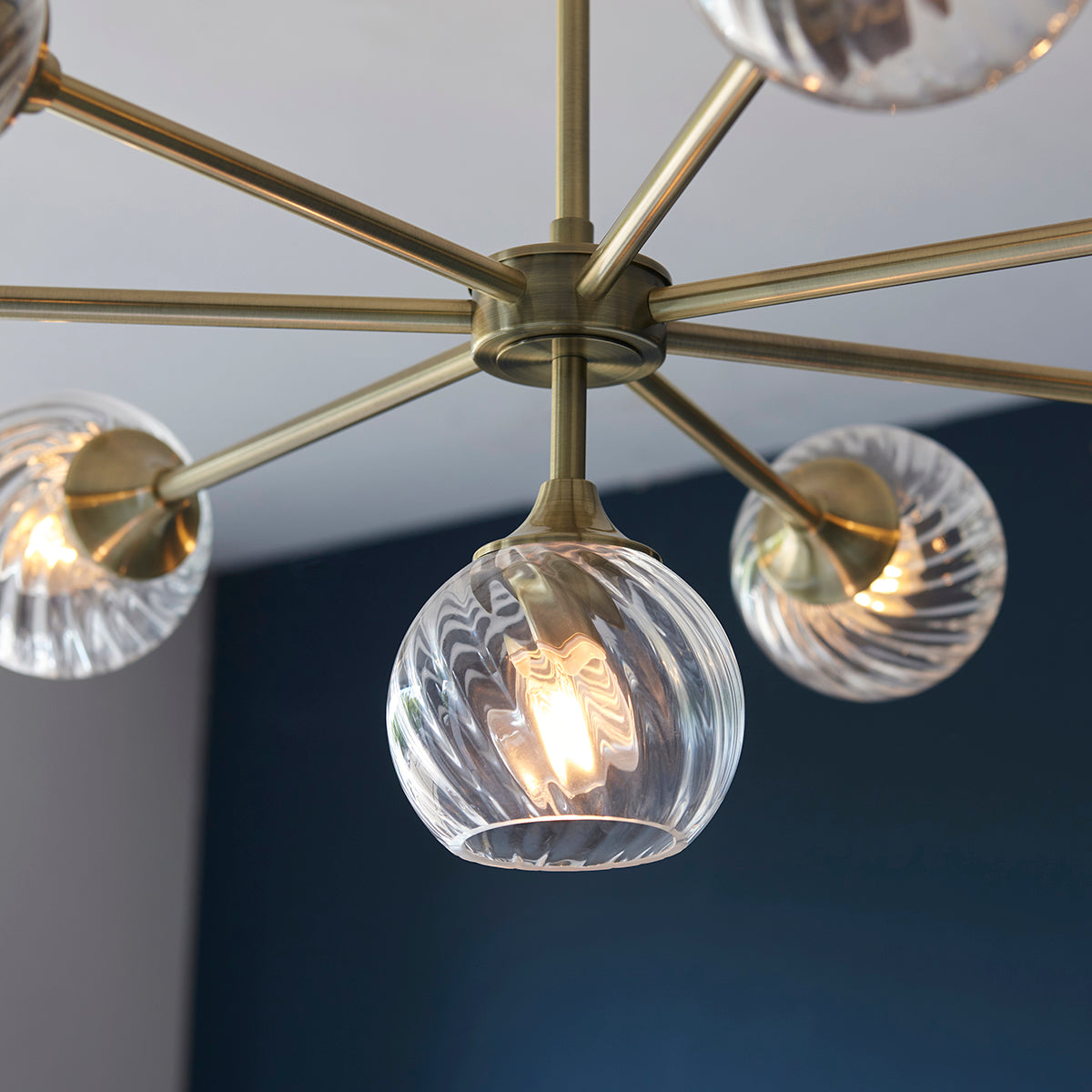 Madeline Spiral Glass Eight Light Pendant in Antique Brass